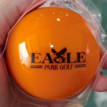 Orange golf ball with 'Eagle Park Golf' branding.
